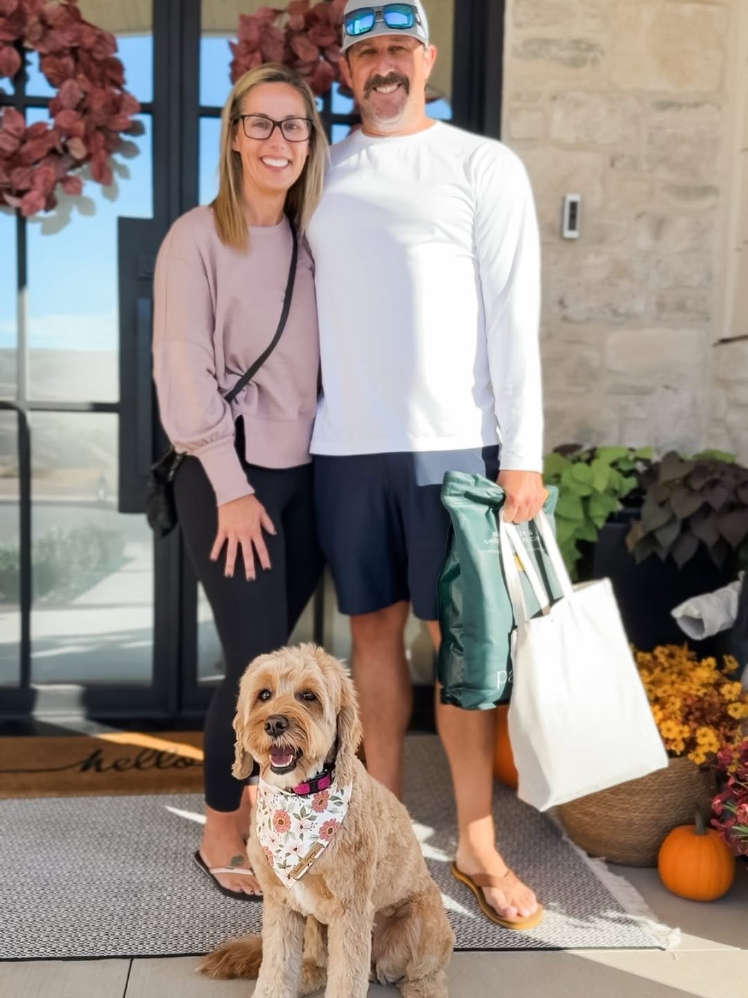 Family visiting a doodle puppy at the breeder's home