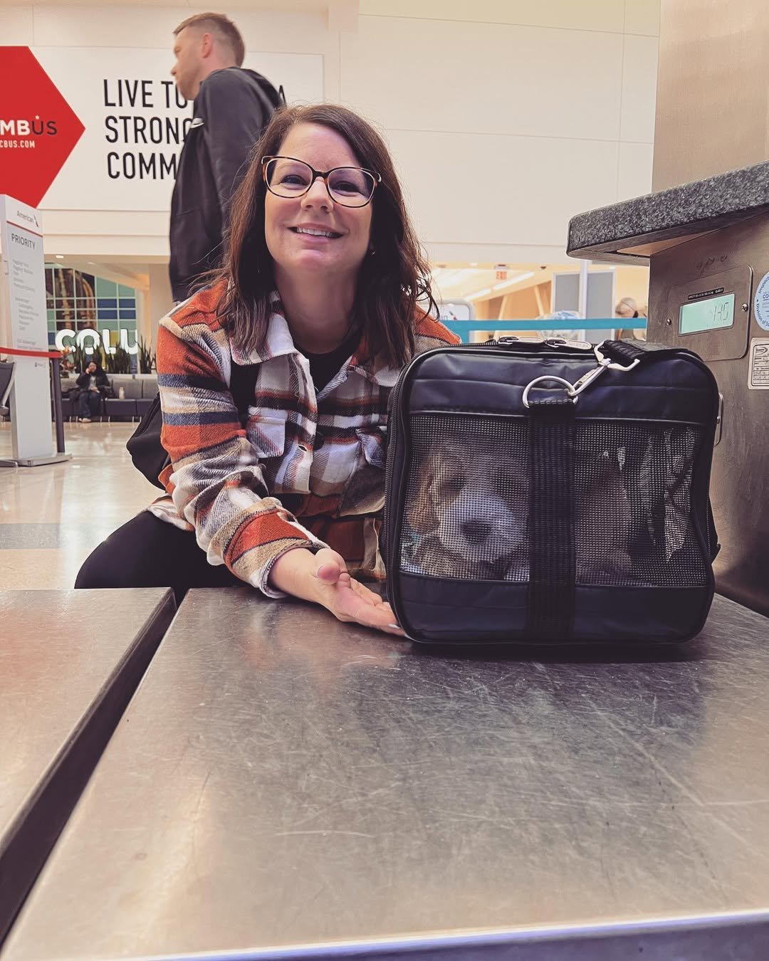 Labradoodle puppy held by its new family on going-home day